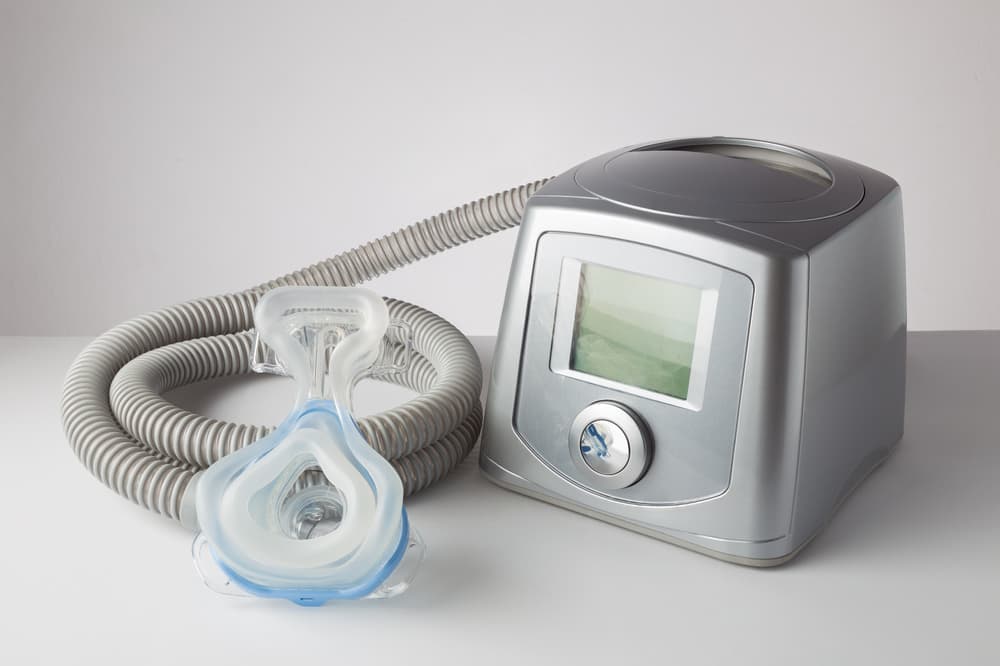 CPAP machine with mask and hose, for people with sleep apnea, respiratory, or breathing disorder
